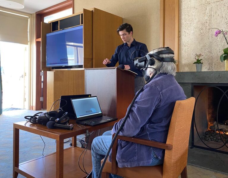 A resident engaging in virtual reality with staff supervision