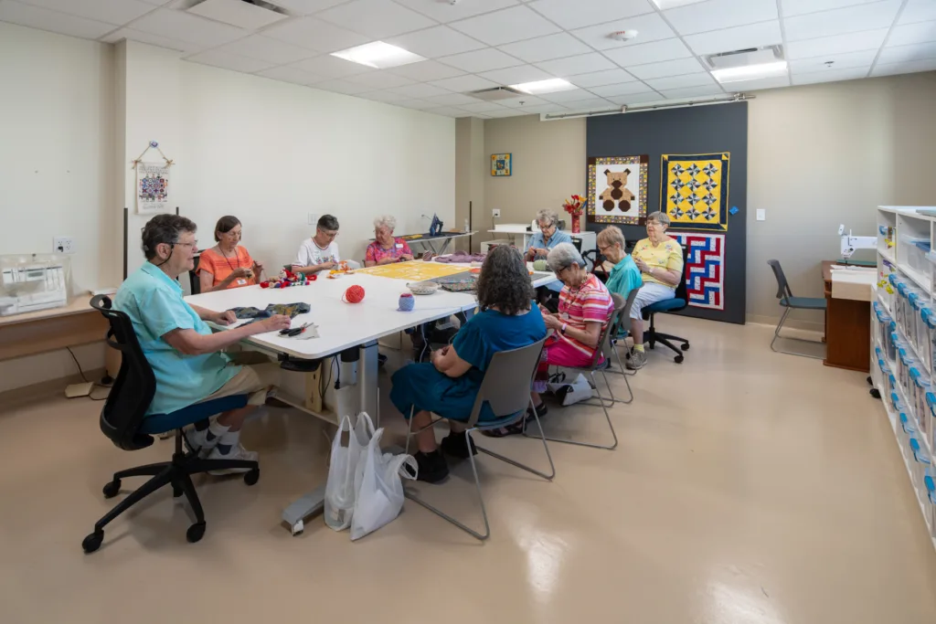 Residents engaged in a craft activity in a common area