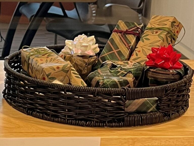 A basket of wrapped gifts on a table