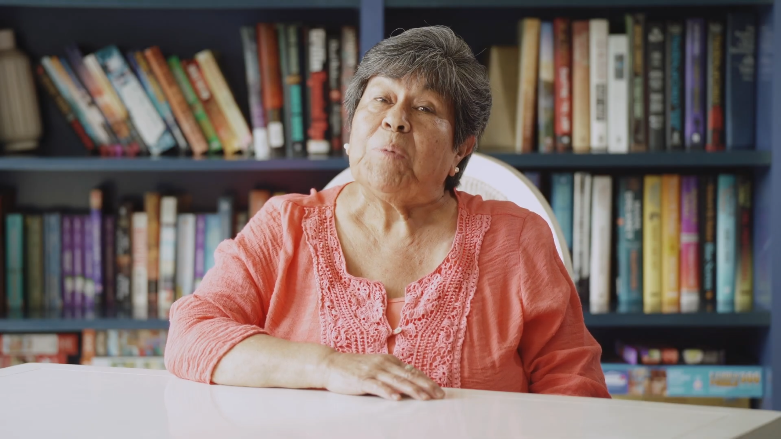 Resident enjoying a moment in a bright library area