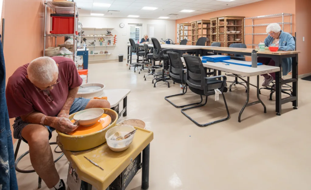 Residents engaging in pottery in a crafting room