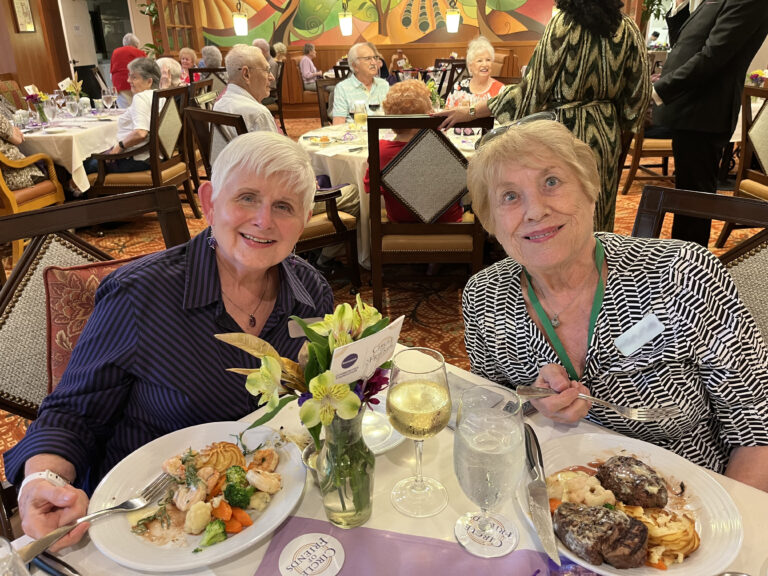 Two residents enjoying dinner in the dining room