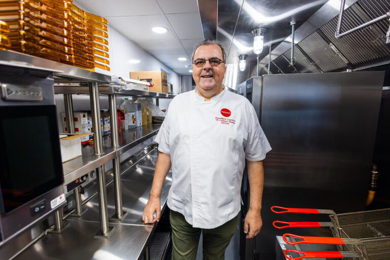 A chef standing in a spacious kitchen