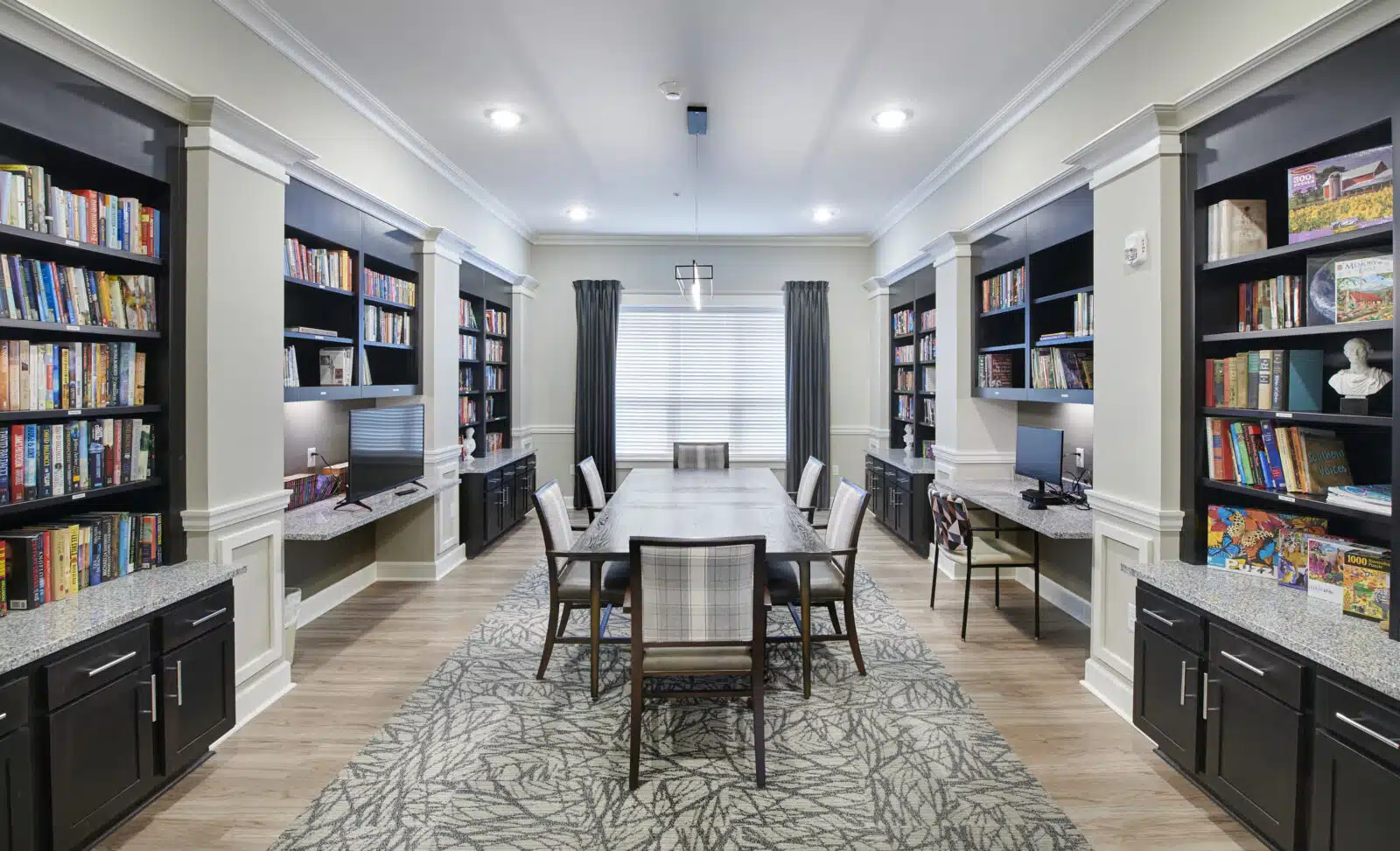 Interior of a cozy library with bookshelves and a table