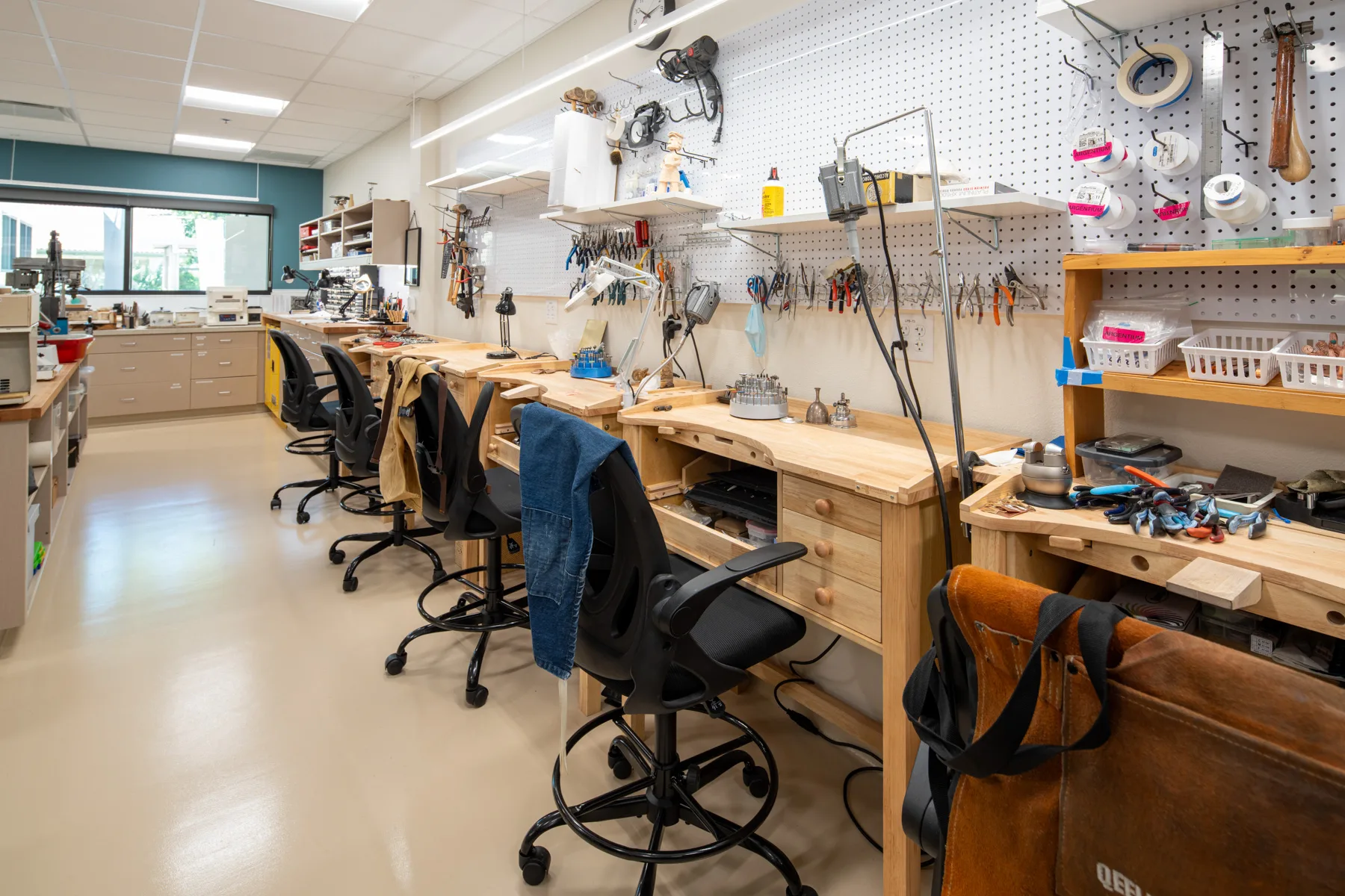 Interior of a workshop with workstations and tools.
