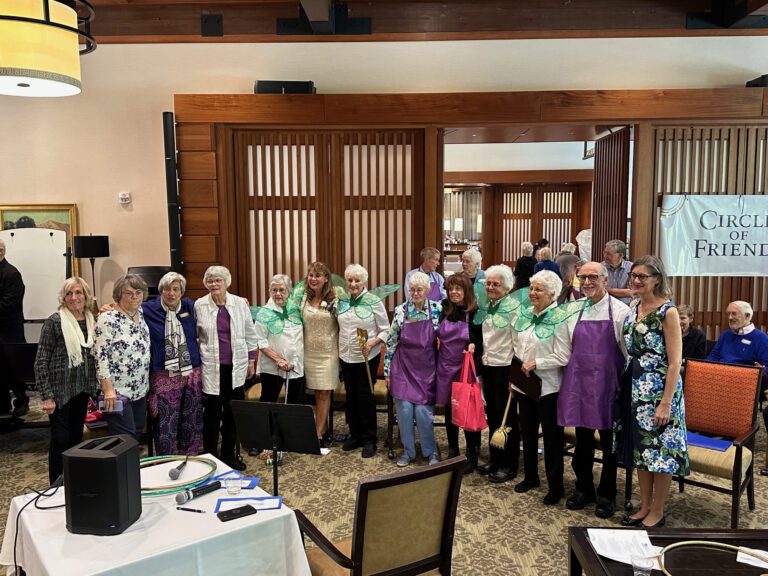 Residents and staff smiling together during an event