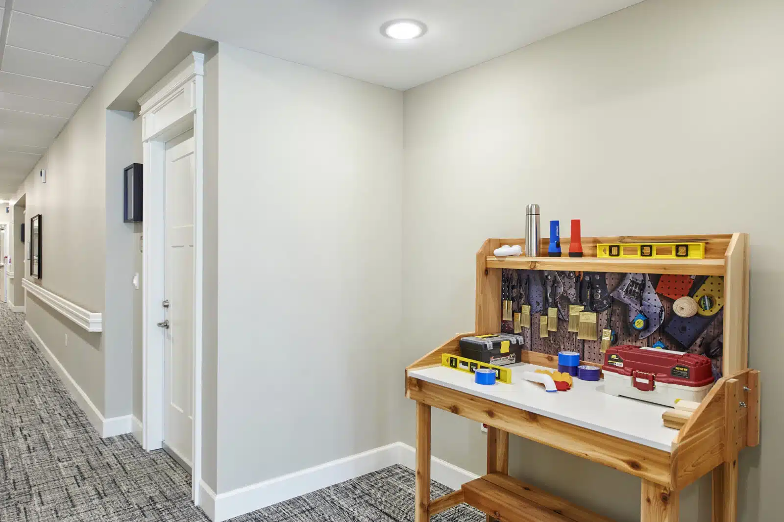 Activity table with tools in a hallway