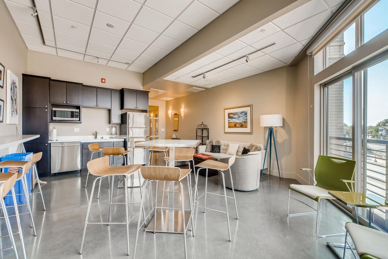 Bright common area with seating and kitchenette