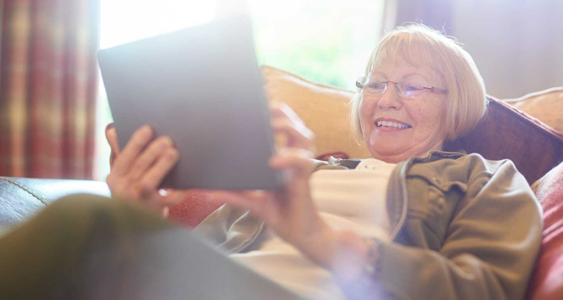 Senior woman using a tablet in a cozy setting