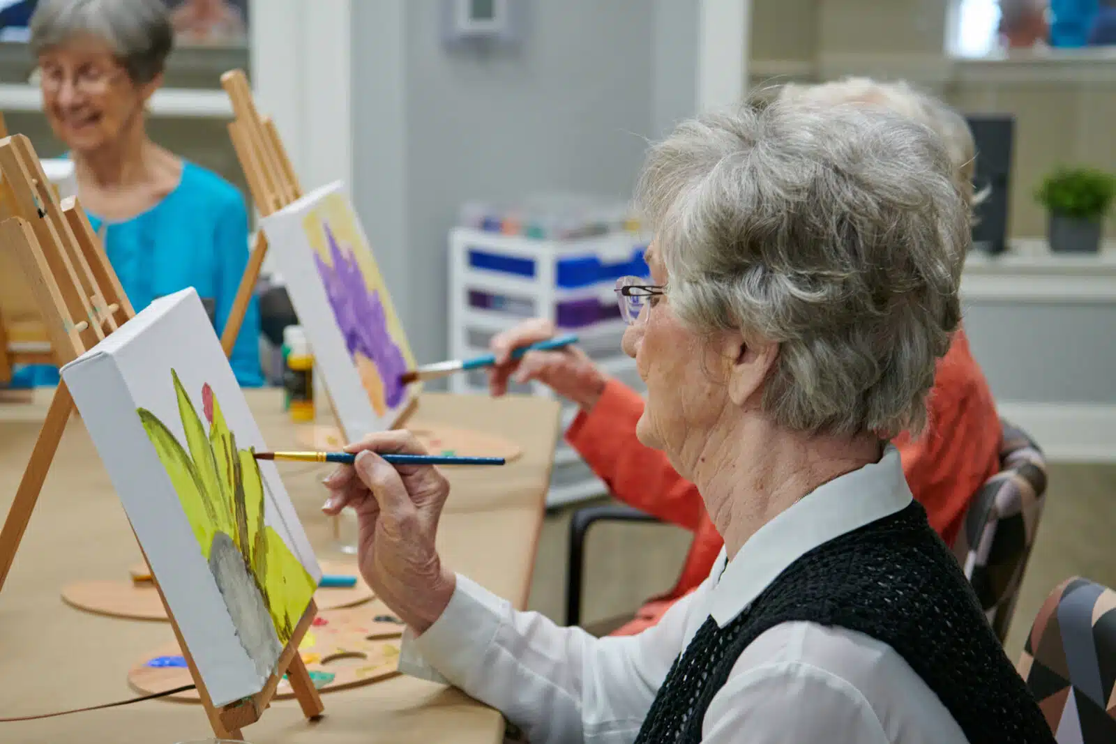 Residents painting in an arts and crafts activity.