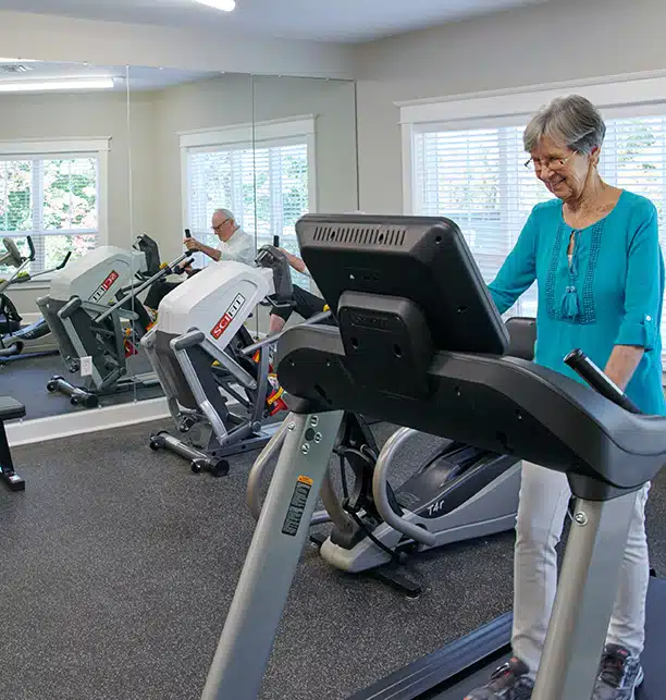 Resident using exercise equipment in the fitness room