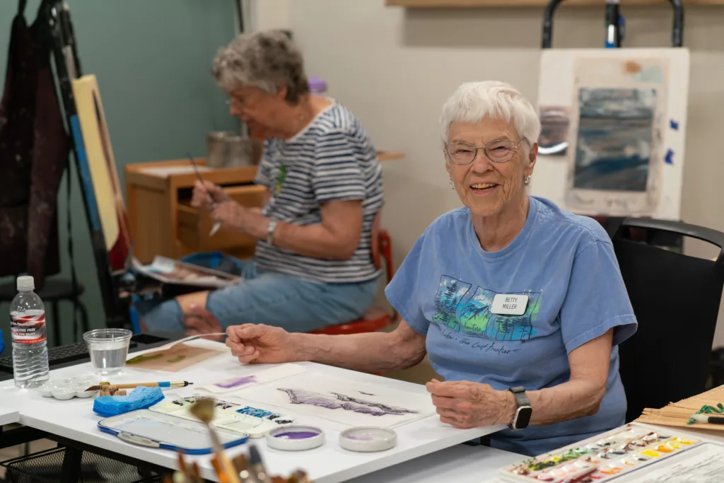 Residents engaged in an art activity in the facility