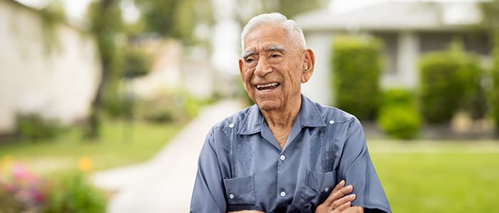 Senior man smiling in a garden setting