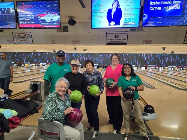 Residents enjoying a bowling activity together