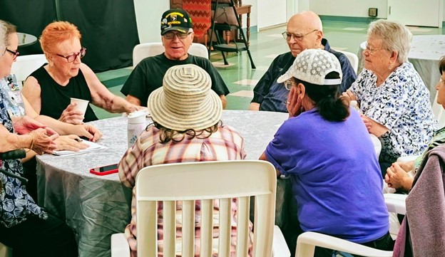 Residents enjoying a group activity around a table