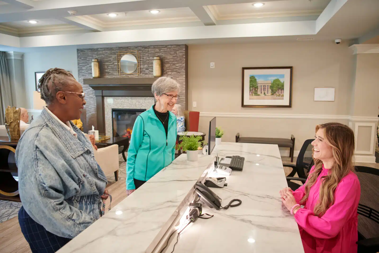 Residents interacting with staff at the reception desk
