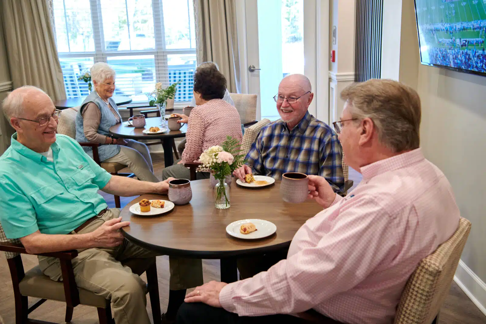 Residents enjoying snacks and coffee in a dining area