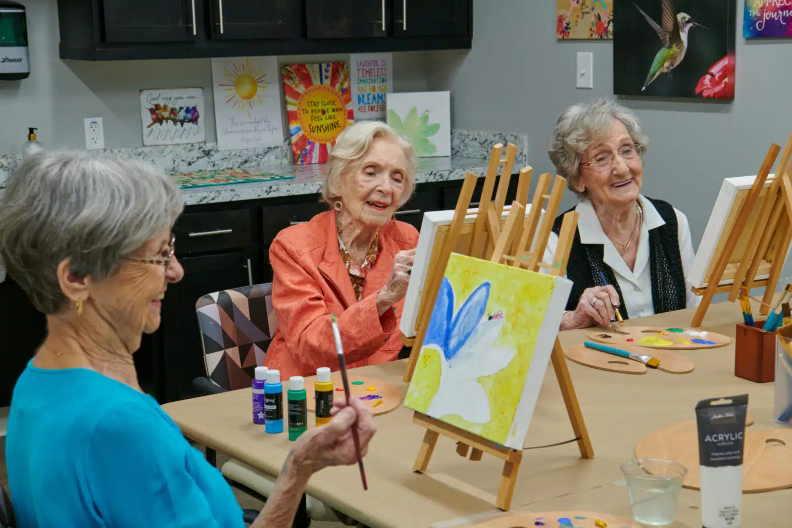 Residents enjoying a painting activity in the facility.