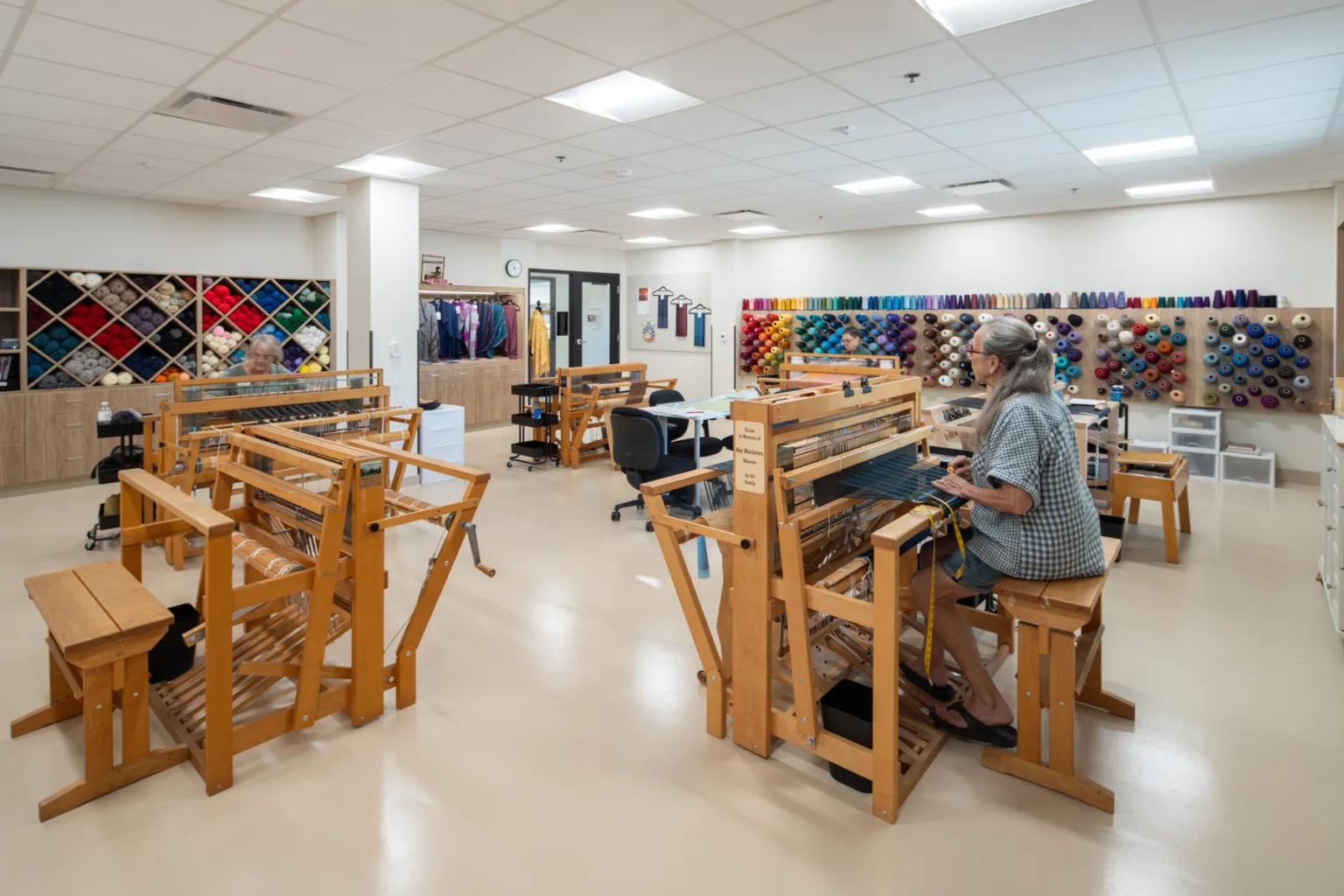 Resident engaging in a weaving activity in a craft room
