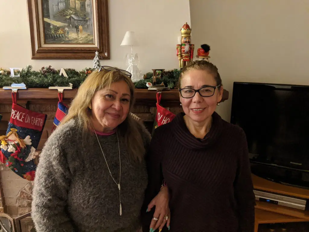 Residents smiling together in a cozy interior setting