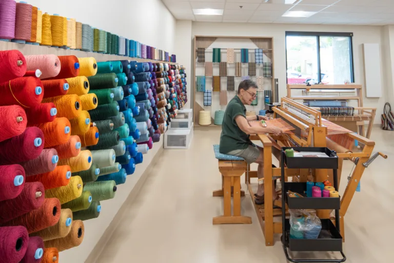 Resident weaving in an arts and crafts room