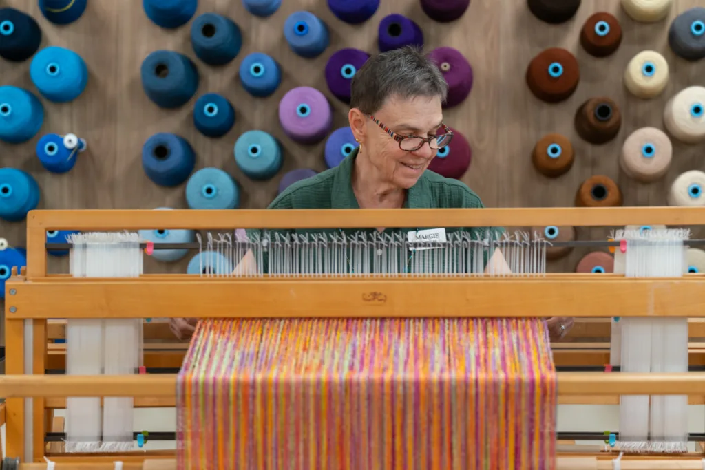 Resident engaged in weaving activity in a common area