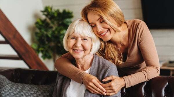 A caregiver embracing a senior resident in a cozy setting