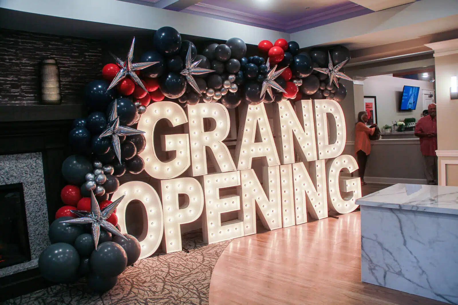 Grand opening celebration with decorative lights and balloons