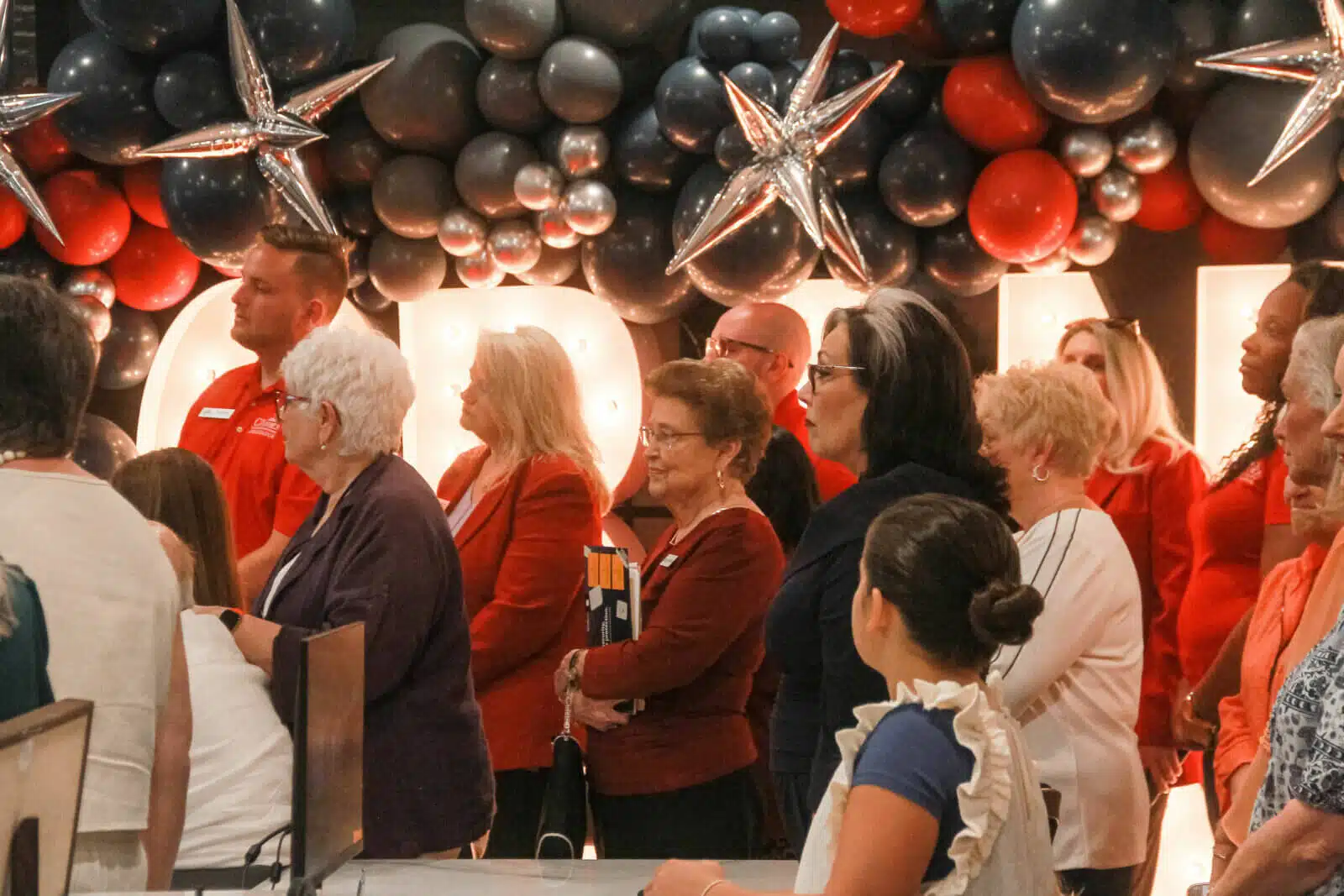 Residents and staff at a celebration event indoors