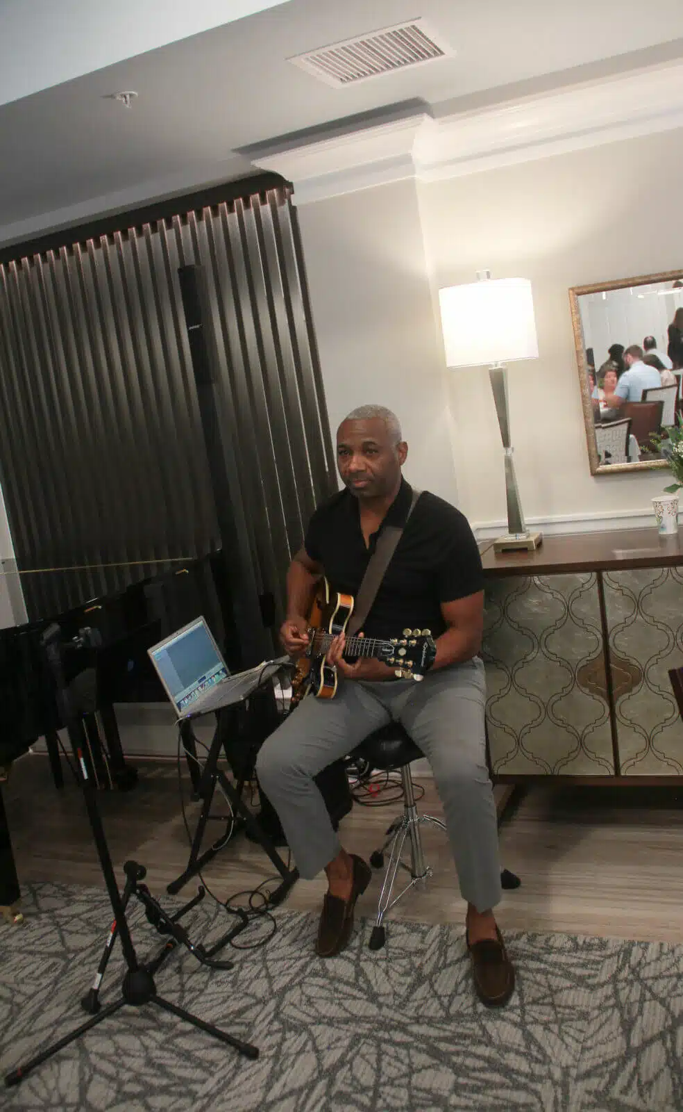 Musician performing for residents in a lounge area