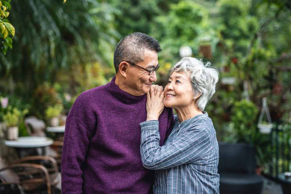 A couple enjoying time together outdoors in a garden setting