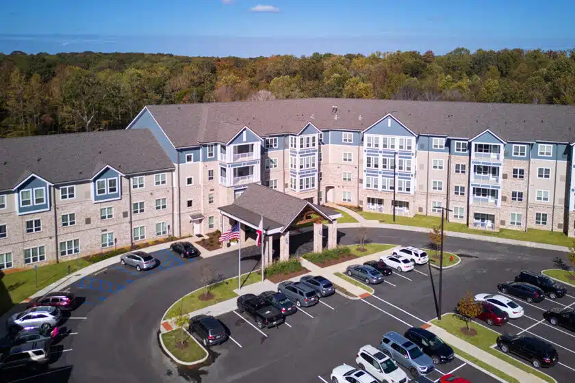 Aerial view of the facility with parking lot and building