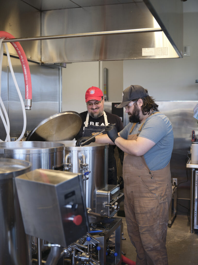 Two staff members cooking in a kitchen
