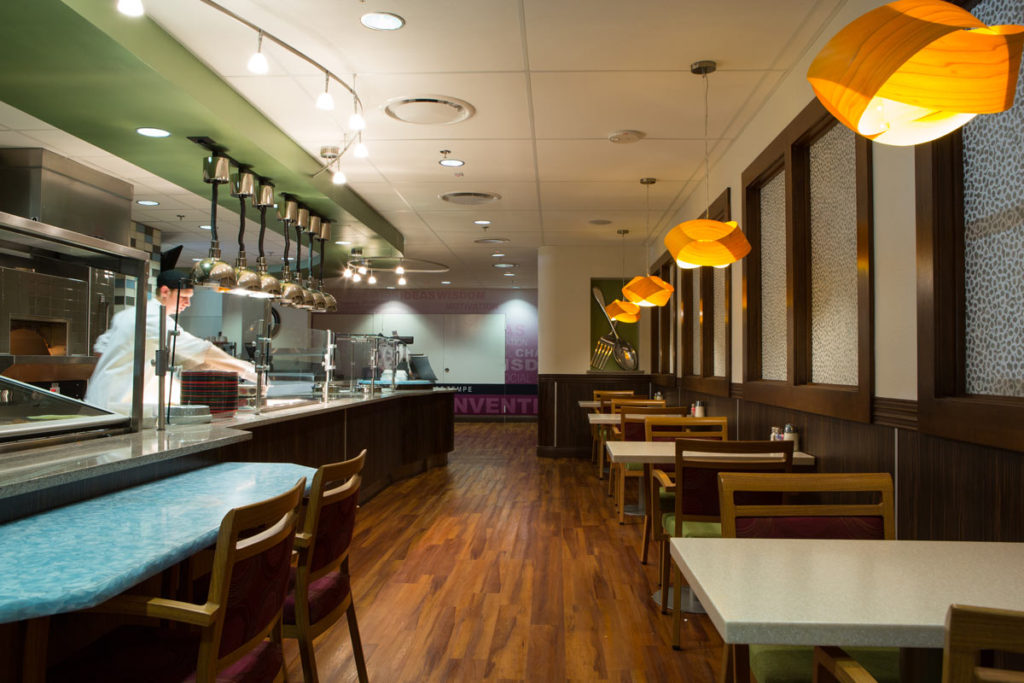 Bright dining area with wooden tables and hanging lights