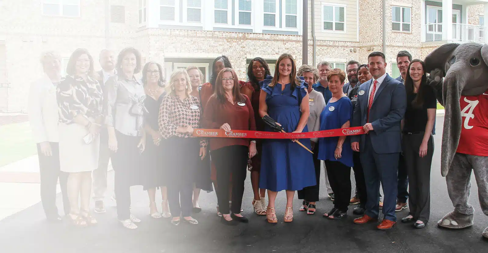 Ribbon-cutting ceremony with staff and community members