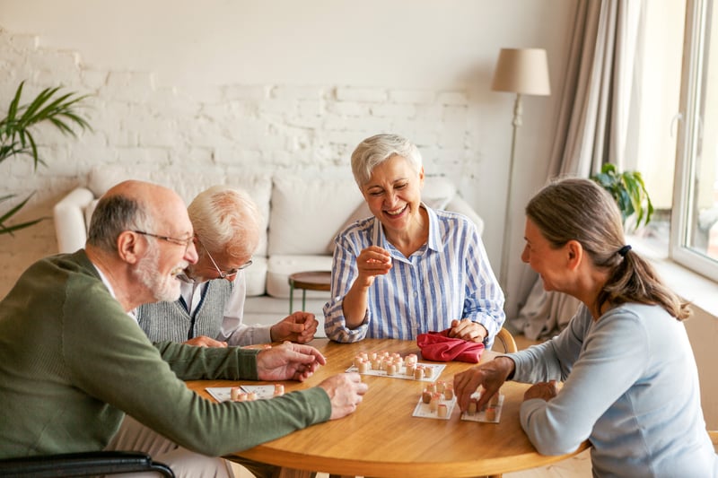 Seniors enjoying a game together in a common area