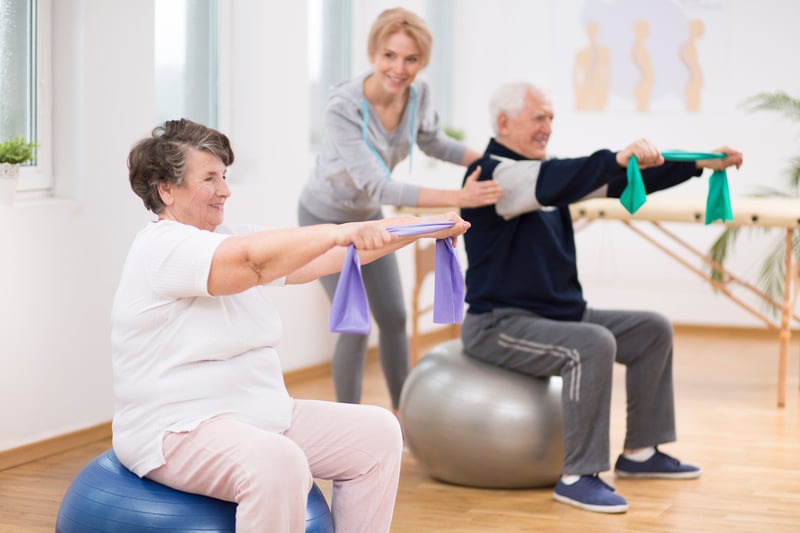 Residents participating in a fitness activity with staff