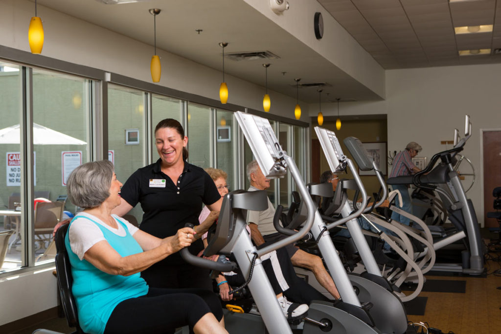 Residents engaging in exercise with staff assistance