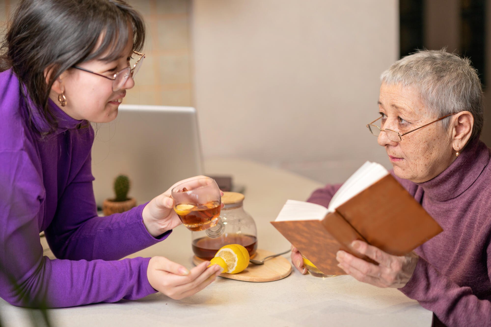 Staff member serving tea to a senior resident