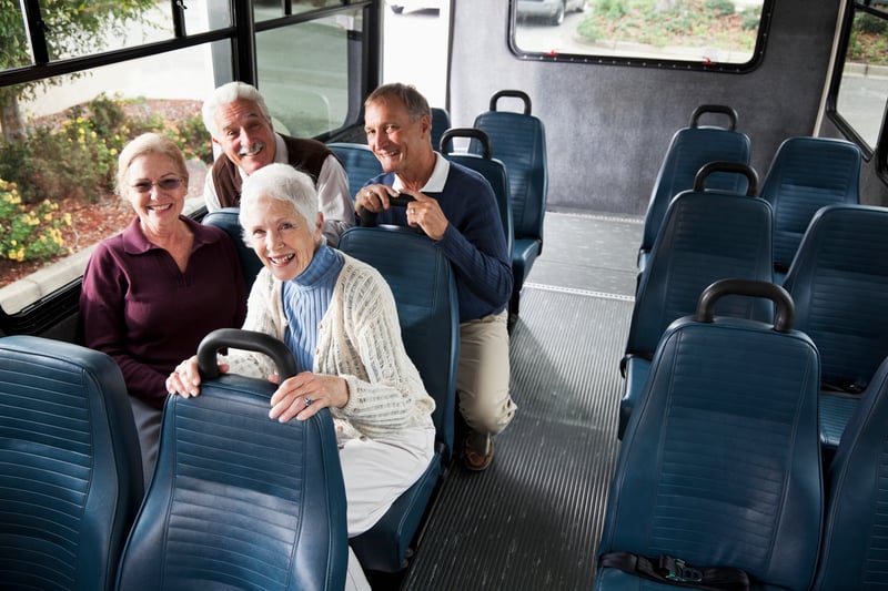 Residents and staff enjoying a ride on a facility transport bus