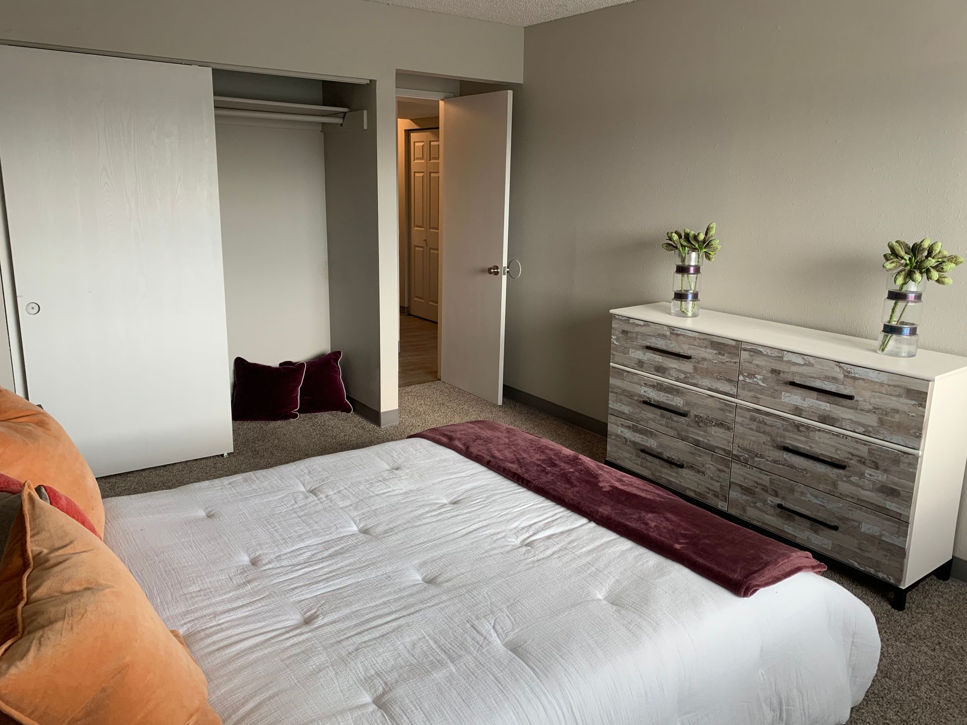 Cozy, well-furnished private room with a bed and dresser