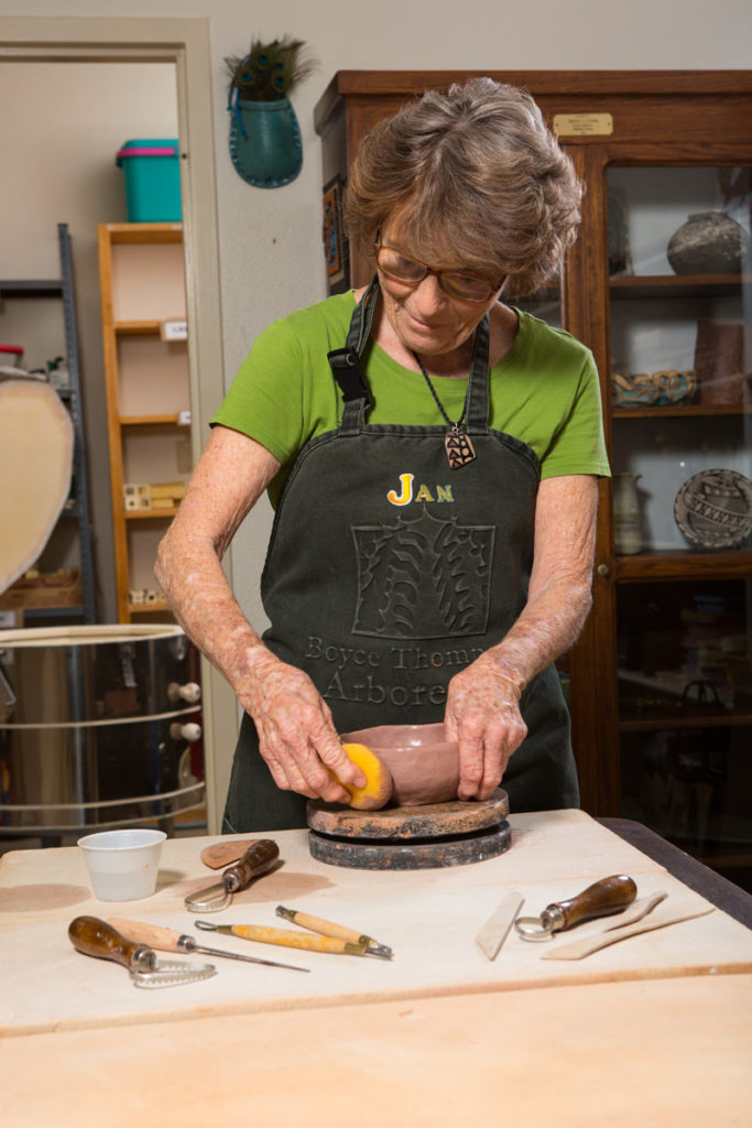 Resident crafting pottery in an art studio