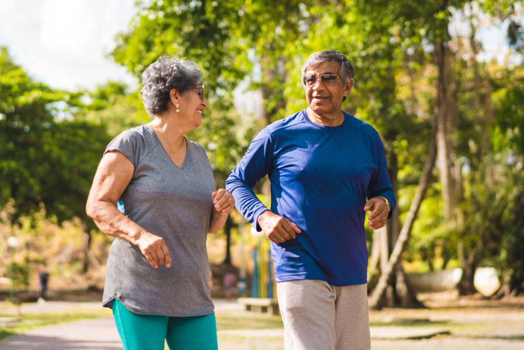 Two seniors enjoying a walk in a park
