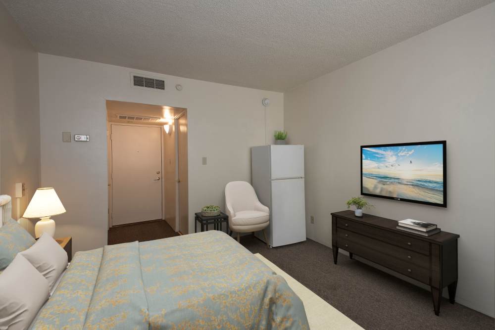 A private resident room with bed and TV