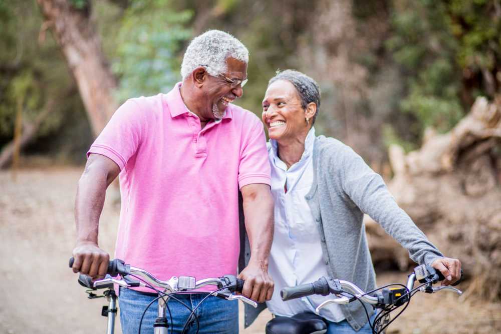 A senior couple enjoying biking together outdoors