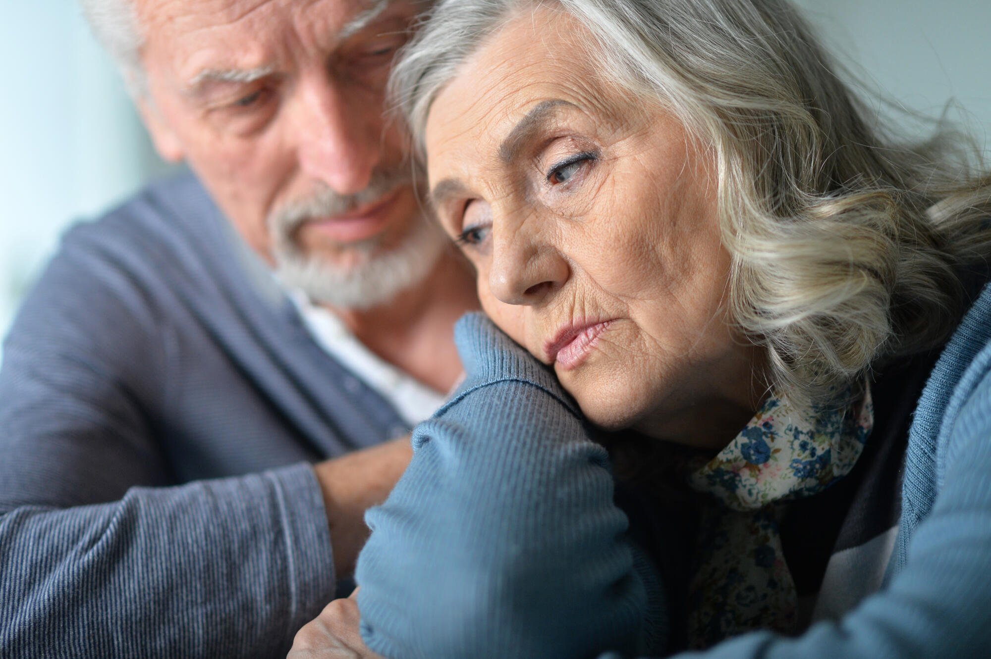 An elderly couple sharing a moment of affection