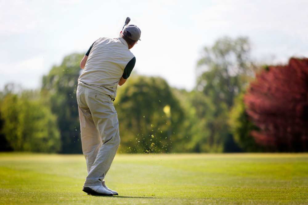 Person golfing on a sunny outdoor course