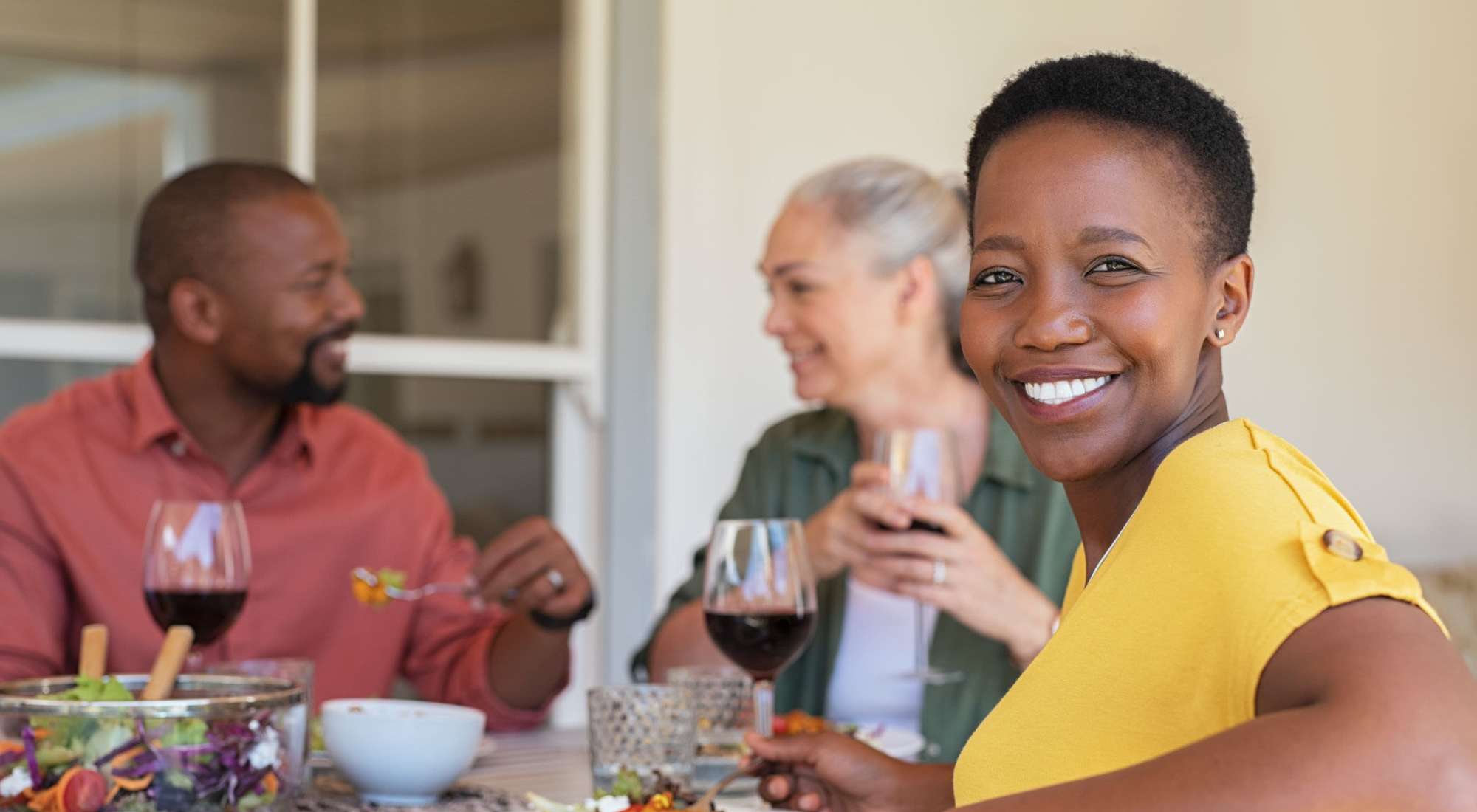 Residents enjoying a meal together with drinks