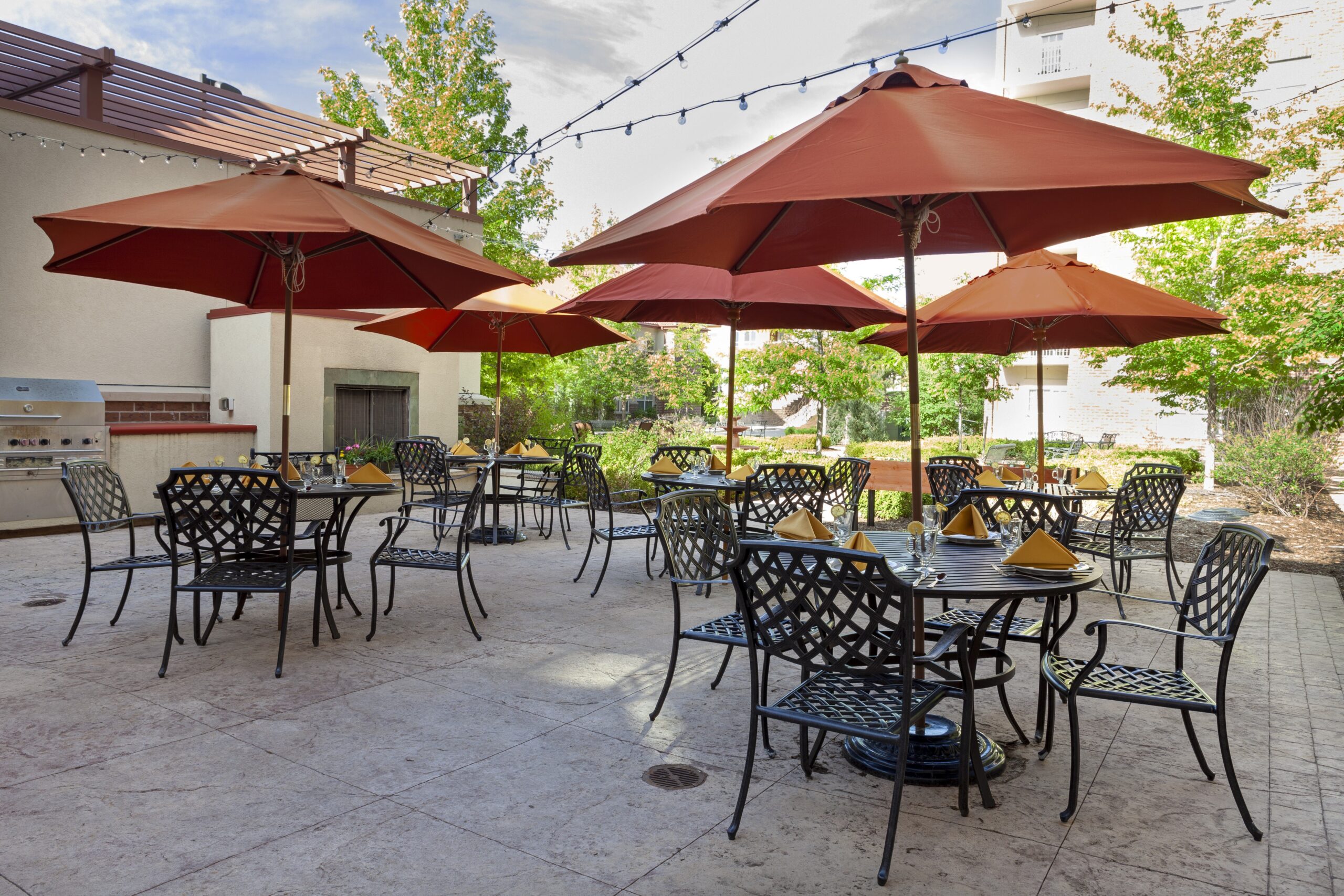Outdoor dining area with tables and umbrellas