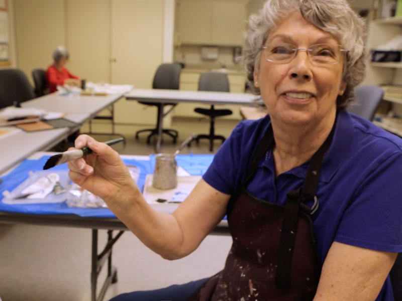 Resident engaging in an art activity in a common area
